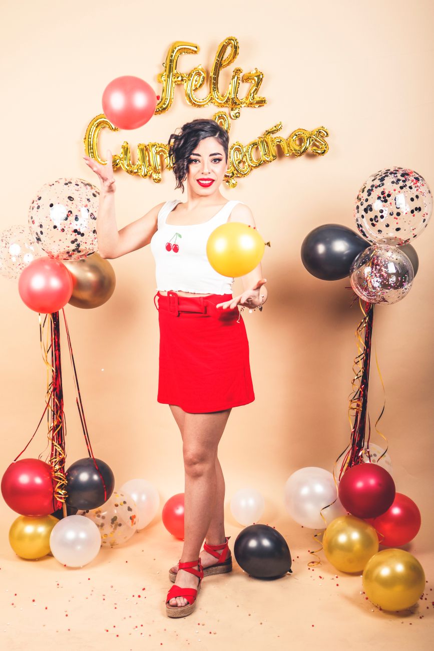 brunette woman with birthday balloons